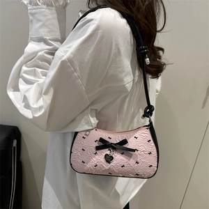 Pink crescent underarm bag with black bow patterns and a heart pendant for women