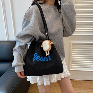 Chic black canvas tote bag with Beach print and cute toast plush charm for women