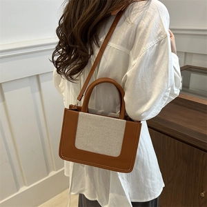 Brown leather and beige canvas拼接 square tote bag worn by model for daily commute