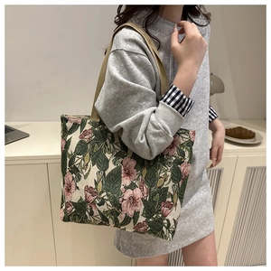 Detail of vintage floral jacquard pattern and sturdy woven handles on a large tote bag