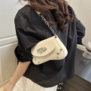 White crescent underarm bag with metal buckles and silver chain strap on model