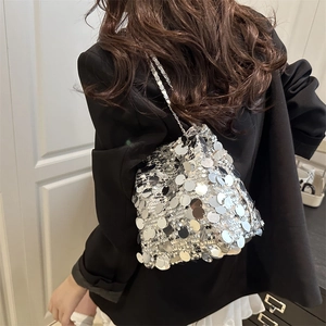 Chic silver sequin bucket bag with metal chain strap shown as a stylish crossbody accessory
