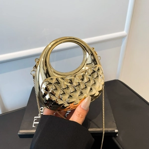 Gold acrylic handbag for women, chic metal chain crossbody bag with structured round handle.