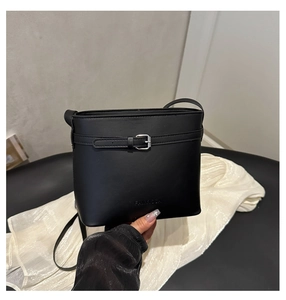 Detailed shot of black bucket bag featuring silver buckle and FANTASCA logo embossing