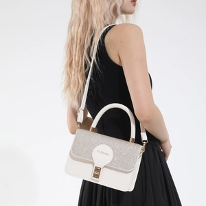 Minimalist cream shoulder bag with silver glitter flap and gold rotary buckle lock
