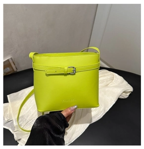 Close-up of neon green bucket bag with Fanyissa brand logo and glossy leather texture