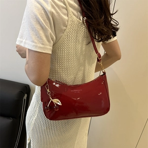 Red patent leather underarm bag with cherry charm and golden zipper for women