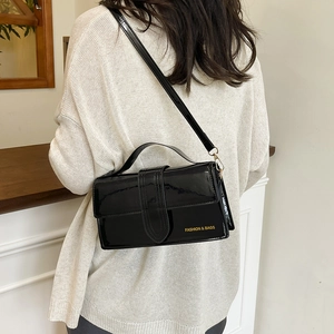 Elegant black patent leather crossbody bag for women with gold hardware and top handle