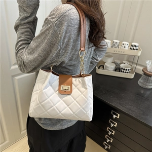 White quilted shoulder bag with brown flap and gold chain strap in modern style
