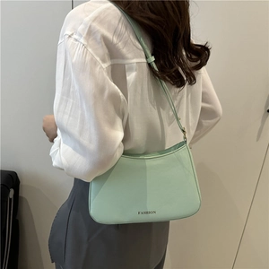 Minimalist mint green baguette shoulder bag with fashion text and gold hardware detail