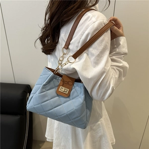 Chic quilted light blue shoulder bag with woven chain strap for professional commuting