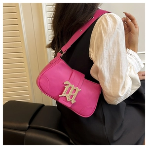 Detail shot of hot pink PU baguette bag with large silver metal buckle on leather strap