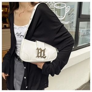 Close-up of white PU leather baguette bag with vintage metal BL logo and shoulder strap