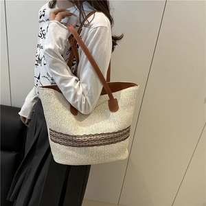 Chic woven straw tote bag with brown lace pattern and leather straps for daily commute