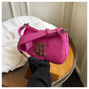 Detailed shot of Y2K style hot pink PU leather shoulder bag with gothic metal logo