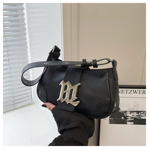 Close-up of black retro PU baguette bag with silver gothic B logo and adjustable strap