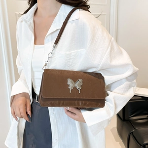Brown crinkle leather shoulder bag with silver butterfly and chain strap detail
