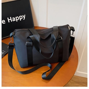 Detail view of durable black oxford travel bag with reinforced straps and metal hooks