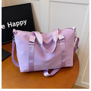 Close-up of a large lavender purple oxford cloth travel bag with adjustable strap