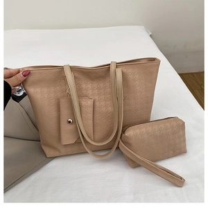 Detail view of beige woven texture tote bag set including handbag and small pouch