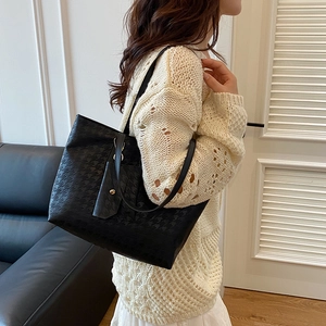 Fashionable black houndstooth embossed tote bag with a matching small pouch for daily use