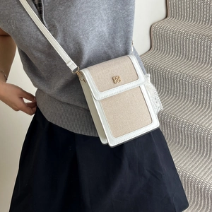 Vertical patchwork crossbody phone bag with clover clasp and cream canvas leather details