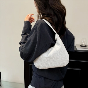 Elegant white woven tote bag hobo style worn on shoulder for stylish minimalist look