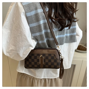Classic monogram crossbody bag with golden metal buckle shown in a stylish side-back view