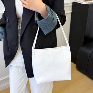 Minimalist white PU leather tote bag with vertical stitching for daily commute