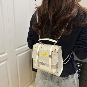 Mini white leather backpack with black polka dots and decorative stylish patches for women