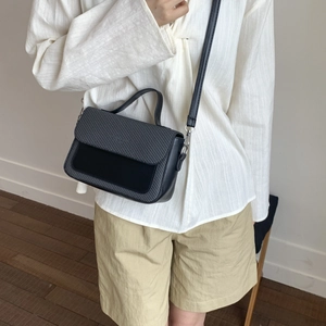 Minimalist black woven flap crossbody bag with silver hardware for daily wear