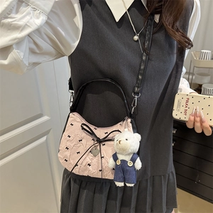 Pink and black crescent shoulder bag with bow prints and a cute plush bear charm