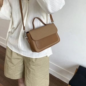 Minimalist brown leather small square bag with woven flap detail and silver hardware strap