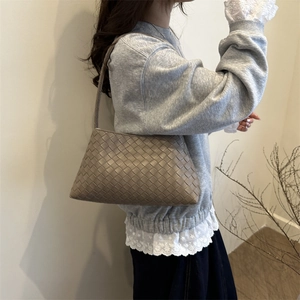 Elegant earth-tone woven hobo shoulder bag for women with a minimalist geometric pattern