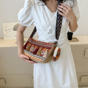 Ethnic bohemian woven bucket bag with tassel, wide strap, and matching round coin pouch