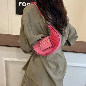 Pink crocodile-embossed crescent shoulder bag with metallic gold accents for women