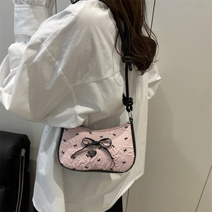 Pink bow underarm baguette bag with black ribbon patterns and heart pendant for women