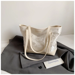 Detail view of the silver abstract texture and FASHION label on large tote bag