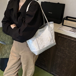 Silver tote bag with metallic marble pattern and FASHION logo on minimalist shoulder strap
