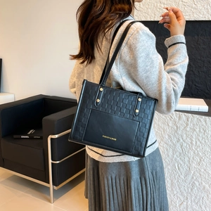 Classic black quilted leather tote bag with elegant thin shoulder straps for women