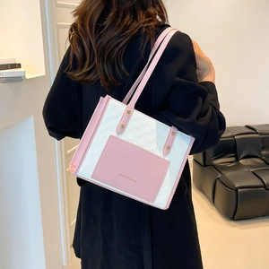 Pink and white tote bag with gold rivets and spacious design for office commute