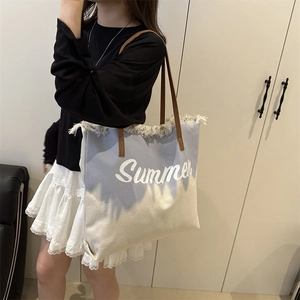 Blue gradient canvas tote bag with Summer embroidery and fringed edges for beach use