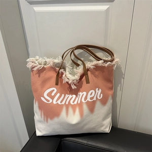 Summer canvas tote bag with orange tie-dye print, frayed edges and leather straps