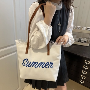 White canvas tote bag with Summer embroidery, brown leather straps and tassel fringe edges