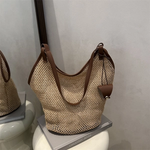 Large straw tote bag with brown leather straps for summer beach vacations and daily use