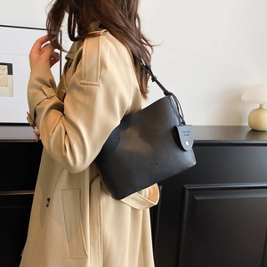 Minimalist black lychee pattern leather bucket bag for women with elegant shoulder strap