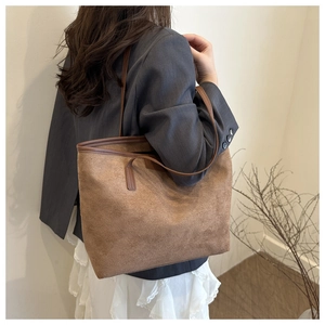 Brown vintage faux suede tote bag styled with a grey blazer and white midi skirt