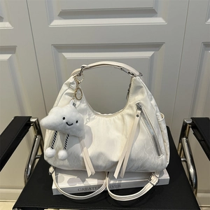 Versatile off-white nylon crescent hobo bag with silver zippers and plush cloud charm