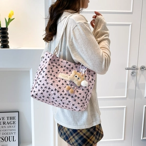 Pink bubble texture tote bag with black bow print and cute plush bear accessory