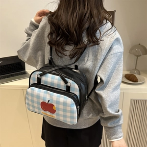Blue and white checkered backpack with red apple print and comfortable shoulder straps